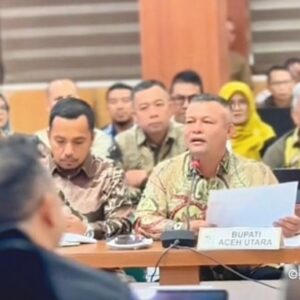 Bupati Aceh Utara Ismail A. Jalil alias Ayahwa saat menyampaikan desakan pemulihan 18.000 hektare sawah rusak dalam rapat Monev TKD di Banda Aceh